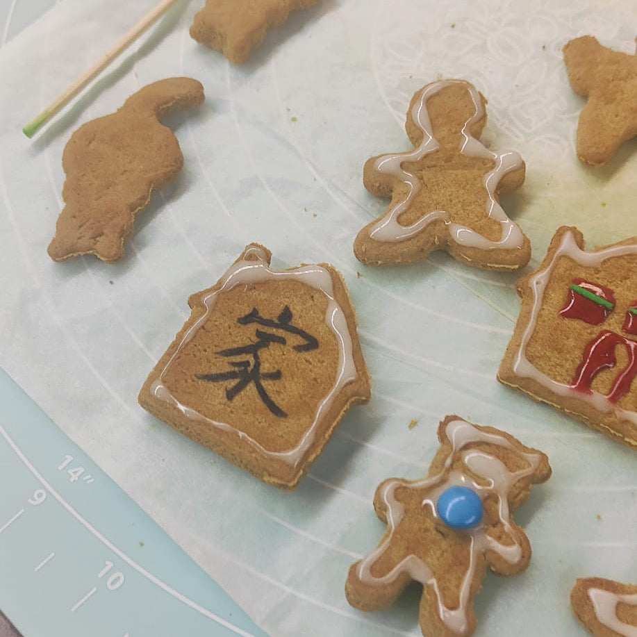 Decorative gingerbread cookies on a cutting board with measurement markings